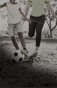 mother and daughter playing soccer